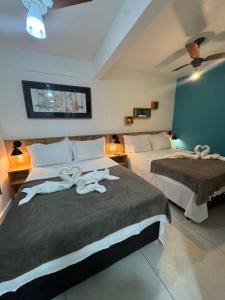 Cama ou camas em um quarto em Pousada Tropical Araçatiba