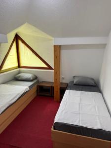 a small room with two beds and a window at Motel MOSKVA in Bijelo Polje