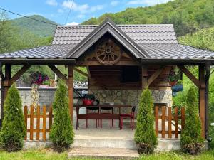 a gazebo with a table and a fence at Motel MOSKVA in Bijelo Polje