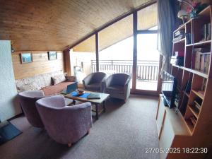 a living room with a couch and chairs and a television at Apartment in Anzère in Anzère