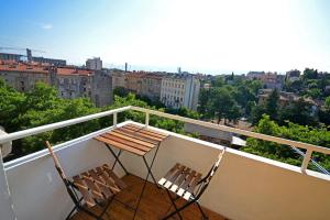 two chairs and a table on top of a balcony at Balcony 4 bedroom apartment by Book-Rijeka in Rijeka