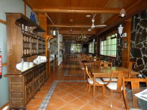 a dining room with wooden tables and chairs at Hotel Rural Camino Medulas in Ponferrada