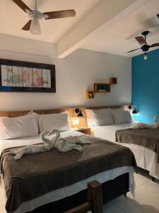 Cama ou camas em um quarto em Pousada Tropical Araçatiba