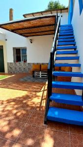 a set of blue stairs leading to a house at Maison avec piscine privée sans vis à vis in Martil +40 photos