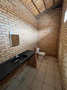 a bathroom with a sink and a toilet at Pousada frente mar in Beberibe