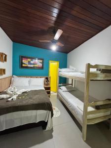Cama ou camas em um quarto em Pousada Tropical Araçatiba