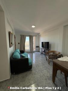 a living room with a couch and a table at Departamentos Rufino in Rufino