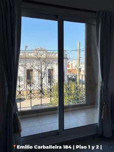 an open window with a view of a building at Departamentos Rufino in Rufino