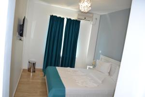 - une chambre avec un lit et un rideau vert dans l'établissement Le Soleil de Paris, à Eforie Nord