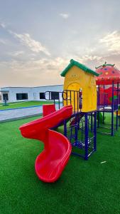 a group of playground equipment on a grass field at Dirat Al-Ghizal 1 in Ras al Khaimah