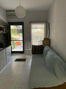 a living room with a large bed and a kitchen at Katerina Beach House in Vergia