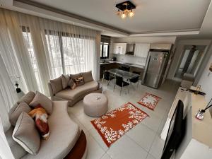 a large living room with a couch and a kitchen at Kyrenia Central Kaşkar region 2 bedroom residence in Prodhromi