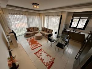 a living room with a couch and a table at Kyrenia Central Kaşkar region 2 bedroom residence in Prodhromi +5 photos