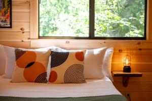 a bedroom with a bed with pillows and a window at Casa de Fruta Cabins, Inn & RV Park in Hollister +26 photos