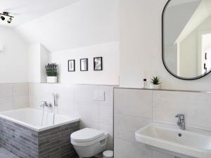 a bathroom with a sink and a toilet and a mirror at Flussblick am Töpferberg 8 in Bad Schwartau +36 photos