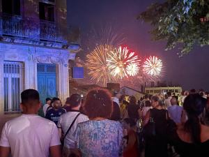 a crowd of people standing in a crowd watching fireworks at Hôtel Paul Riquet in Béziers