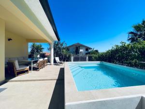 a swimming pool in the backyard of a house at Villa La Brace in Briatico