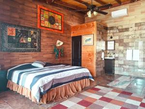 a bedroom with a bed in a wooden cabin at Jimmy & Yudy's place in El Triunfo +25 photos