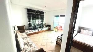 a living room with a couch and a table at Appartement Oued Laou Mekkad in Oued Laou