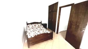 a bedroom with a bed and a mirror and a door at Appartement Oued Laou Mekkad in Oued Laou
