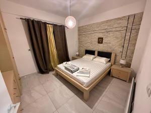 a bedroom with a bed and a brick wall at platamon 3 platania in Platamonas