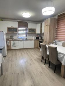 a kitchen and dining room with a table and chairs at Aia Holiday Home in Sarajevo