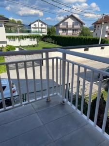 a balcony with a white railing and a car at Aia Holiday Home in Sarajevo +6 photos