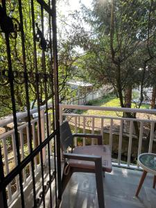 a balcony with a chair and a table at Aia Holiday Home in Sarajevo