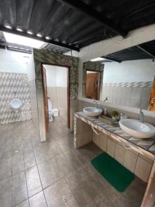 a bathroom with two sinks and a mirror at Finca Castillo de Altura in San Juan +34 photos