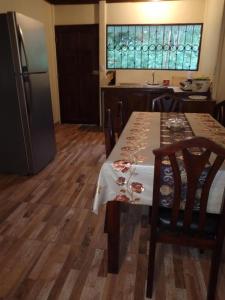 a kitchen with a table and a refrigerator at Cabaña escondida Venecia in Venecia