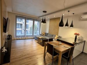 a living room with a table and a couch at Lubicz Apartment 70m2 in Kraków
