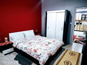 a bedroom with a bed and a red wall at Apartment Diana in Resilovo