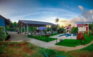 a house with a pavilion and a swimming pool at Le Eden Premium Wayanad Pool Resort in Sultan Bathery