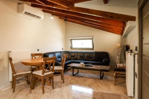 a living room with a leather couch and a table at Sivota Apartment SV in Syvota