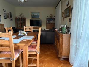 a dining room with a table and a television at Melija Apartment in Orebić