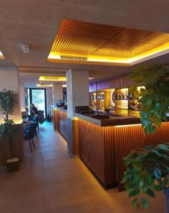 a restaurant with a bar in the middle of a room at Una LUX N85 in Kopaonik