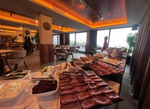 a buffet line with different types of meats and food at Una LUX N85 in Kopaonik