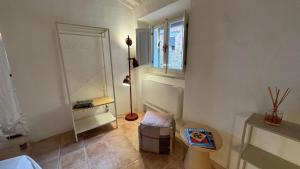 a room with a floor lamp and a chair and a window at SuSuMare in Campiglia Marittima +49 photos