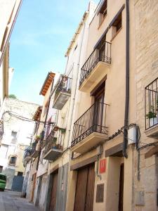 a building with balconies on the side of a street at Luna11 in Alcañiz