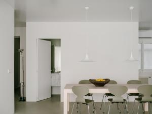 a white kitchen with a table and chairs at Piso GV 65 in Logroño