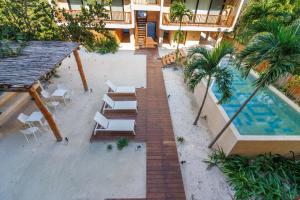 an aerial view of a resort with a swimming pool and chairs at Ocean View 2 Bedroom Apartment in Punta Cocos - A201 in Holbox Island