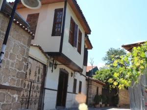 a house with a gate and a fence at Otel Wood House in Antalya