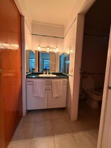 a bathroom with a sink and a toilet at Chalet Buenos Aires in Buenos Aires +20 photos