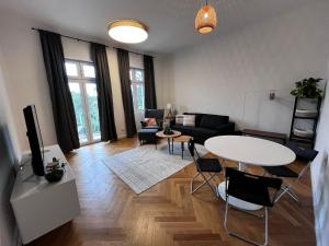 a living room with a table and a couch at Zur Kaiserin - im Süden Berlins in Berlin
