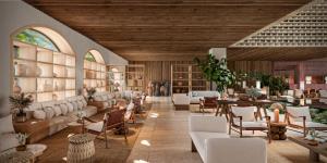 a large room with tables and chairs and people in the background at Kimpton Tres Rios - All Inclusive in Playa del Carmen