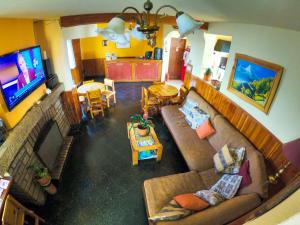 a living room with a couch and a television at Refugio Patagonia Hostel in San Carlos de Bariloche
