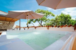 a swimming pool with an umbrella and an umbrella at Hotel Casa Kavia Vallarta in Puerto Vallarta