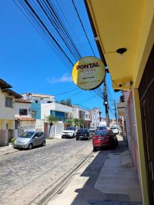 a sign for a restaurant on the side of a street at Pontal Hostel FLAT ilheus in Ilhéus
