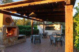 a patio with a fireplace and a table and chairs at Casa Vacanze Il Sole in Casamassella