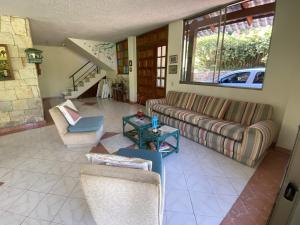 Una sala de estar con sofás y una mesa. en Casa en Condominio vía Villeta, en Nimaima